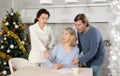 Married couple helps elderly mother write testament in kitchen at christmas Royalty Free Stock Photo