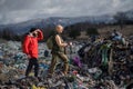 Man and woman hikers on landfill, environmental concept.