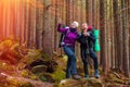 Man and Woman Hikers Staying in Dense Old Forest Smiling and Pointing Royalty Free Stock Photo