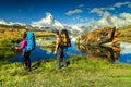 Man and woman hikers trekking in mountains, Valais, Zermatt, Switzerland