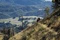 Man And Woman Hiking On Mountain Trail