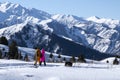 Man and woman are hiking in snow mountains with dog. Royalty Free Stock Photo