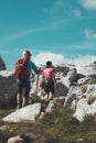 Man and a woman hiking up a rocky mountain side in Durmitor mountains Royalty Free Stock Photo