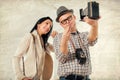 Man and woman hold retro camera. Texture background Royalty Free Stock Photo