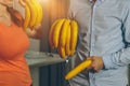 Man and woman holding bananas