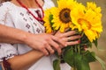 Man and woman holding a bouquet of sunflowers. ukrainian wedding