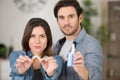 man and woman holding broken cigarette and vaping machine