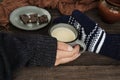 Man and woman holding cup of hot chocolate.Cozy mood and sweet winter drink.Cup of hot chocolate, scarf, pieces of chocolate and h Royalty Free Stock Photo