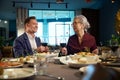 Man and woman holding glasses with red wine toasting celebrating New Years Eve