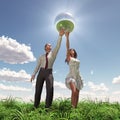 Man and woman holding globe