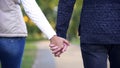 Man and woman holding hands back view, living life together, romantic date