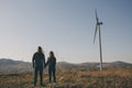 Romantic multi-ethnic couple admires the scenic sunset over the mountain. Holding hands, rear view. Harmony in Royalty Free Stock Photo