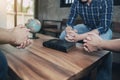 man and woman holding hands prays together around wooden table with blurred bible and world globe, Christian concept, Royalty Free Stock Photo