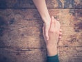 Man and woman holding hands at a table Royalty Free Stock Photo