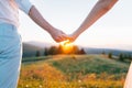 Man and woman holding hands together at sunset Royalty Free Stock Photo