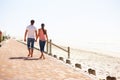 Man, woman and holding hands for walk on beach, back view of romantic date and commitment with trust. Love, care and Royalty Free Stock Photo