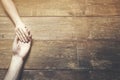 Man and a woman holding hands at a wooden table Royalty Free Stock Photo