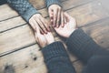 Man and a woman holding hands at a wooden table Royalty Free Stock Photo