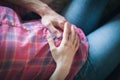 Man and woman are holding a pregnant belly, pregnant mom in a plaid shirt with a husband are holding their hands on her stomach, Royalty Free Stock Photo