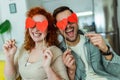 Man and woman at home holding red heart valentine in hands Royalty Free Stock Photo