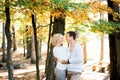 Man and woman hugging under a tree with yellow leaves Royalty Free Stock Photo