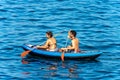 Man and woman on an inflatable kayak in the blue sea - Liguria Italy Royalty Free Stock Photo