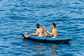 Man and woman on an inflatable kayak in the blue sea - Liguria Italy Royalty Free Stock Photo