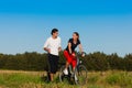 Man and woman jogging and with bicycle Royalty Free Stock Photo