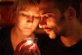 Man and woman keeping glass candle.