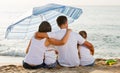 Man and woman with kids sitting with back to camera on beach Royalty Free Stock Photo