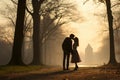 A man and a woman kissing in a park at early morning. Back light sunrise light. Silhouettes of couple in love