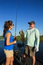 Man and Woman Large Mouth Bass Fishing in Boat Royalty Free Stock Photo