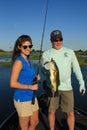 Man and Woman Large Mouth Bass Fishing in Boat Royalty Free Stock Photo
