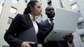 Man and woman looking at laptop outside building, attorneys, brand new evidence Royalty Free Stock Photo