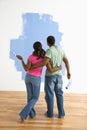 Man and woman looking at paint job. Royalty Free Stock Photo