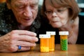 Man and woman looking at prescription medications