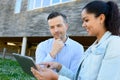 Man and woman looking at tablet stood outside building Royalty Free Stock Photo