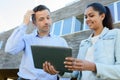 man and woman looking at tablet stood outside property Royalty Free Stock Photo