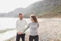 Man and woman in love enjoying together near sea, running by the beach, laughing Royalty Free Stock Photo