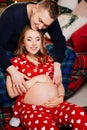 man and woman in love. family in pajamas in the New Year& x27;s bedroom. pregnancy