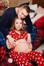 man and woman in love. family in pajamas in the New Year& x27;s bedroom. pregnancy