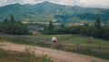 Man and woman in love sit on the fence near the village in the mountains Royalty Free Stock Photo