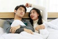 Man and woman lovers laying on bed and sharing sweet time together in winter season Royalty Free Stock Photo