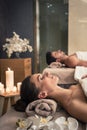 Man and woman lying down on massage beds at Asian wellness center Royalty Free Stock Photo