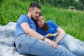 A man and a woman are lying on the grass and reading a book Royalty Free Stock Photo