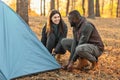 Man and woman making tent together, having conversation Royalty Free Stock Photo