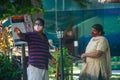 Man and woman in masks chating at the strret during covid-19 pandemic