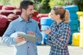 man and woman in materials yard holding tablet