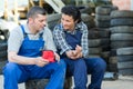 man and woman mechanic looking at arm injure