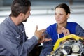 man and woman mechanics baffled work